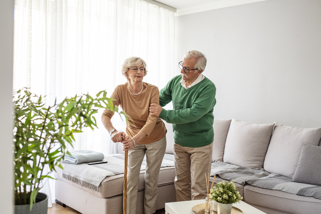 Older man caring for his wife